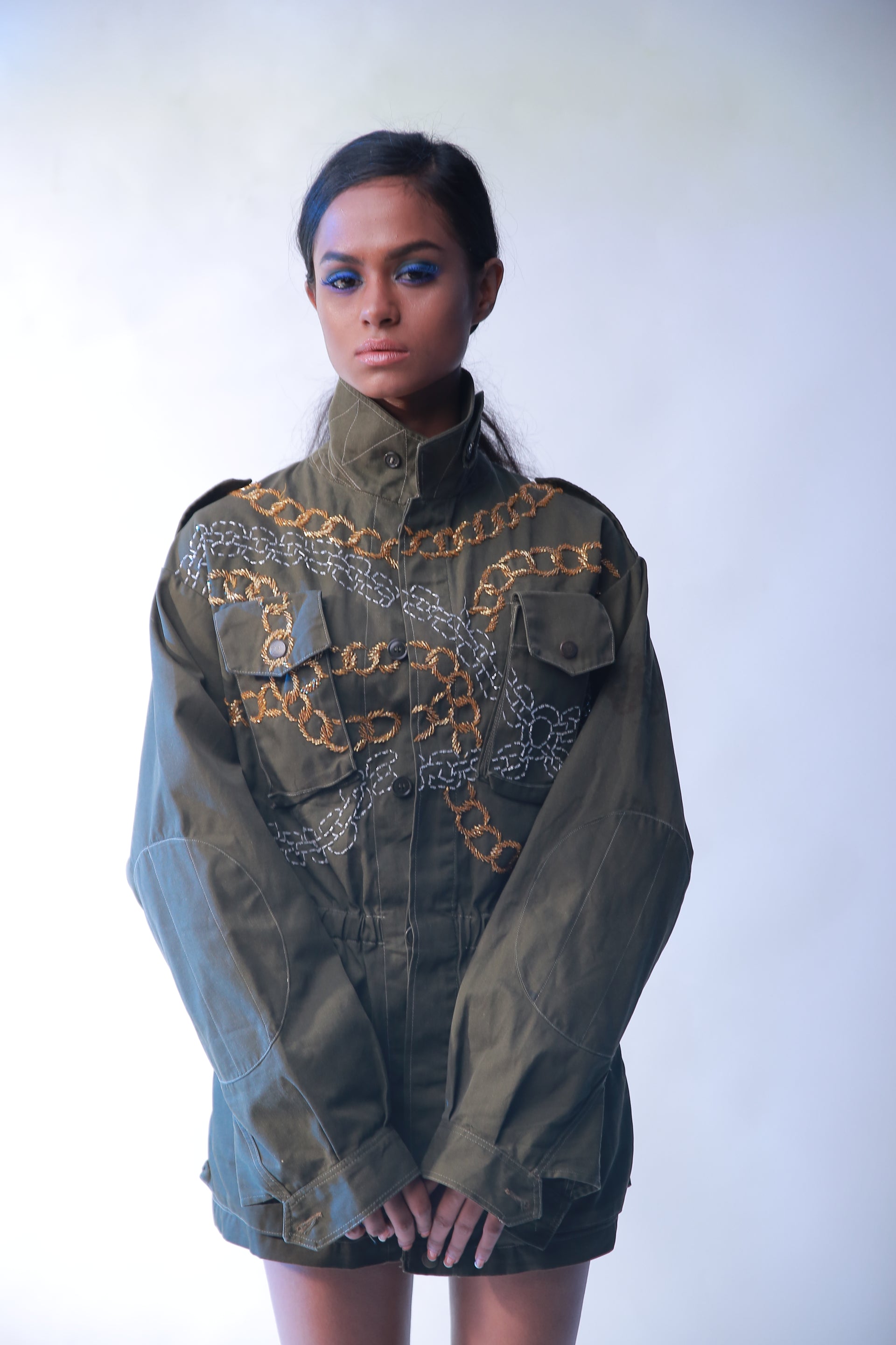 Mini olive green shirt dress with sequins and chain details and front pockets.